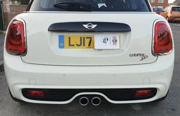 Four rear parking sensors fitted across a white MINI bumper