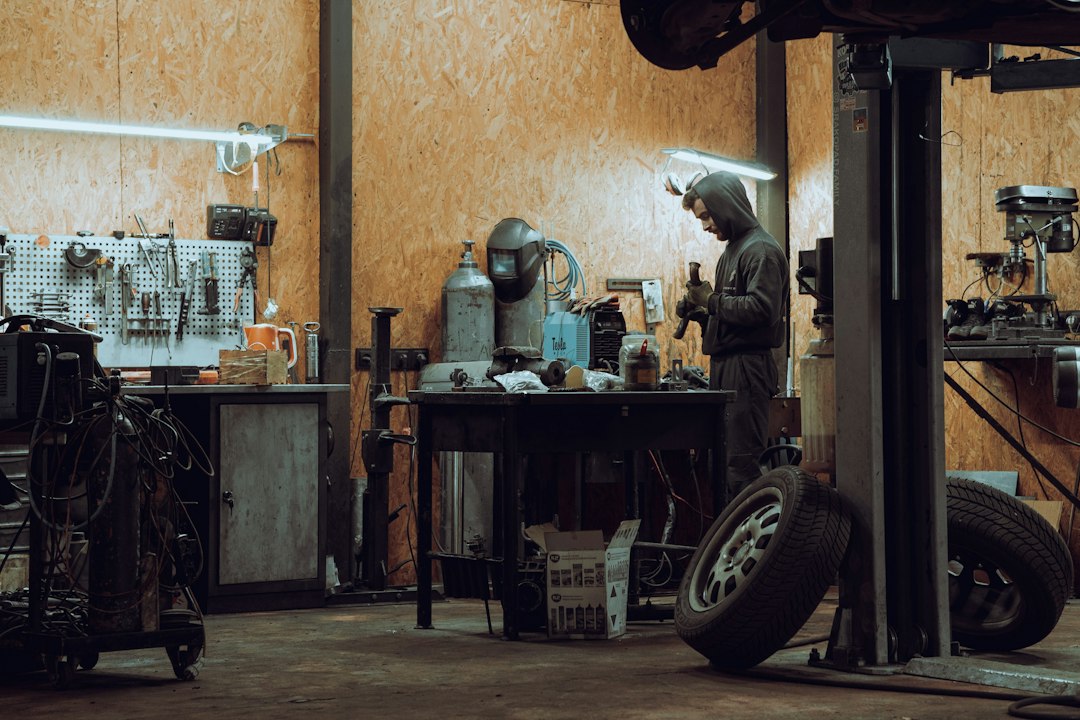 Mechanic using diagnostic equipment in a workshop